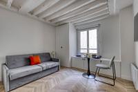 a living room with a couch and a table at New and Designed Studio well Equipped - Heart of Paris 2 in Paris