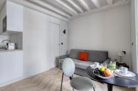 a living room with a table and a couch at New and Designed Studio well Equipped - Heart of Paris 2 in Paris