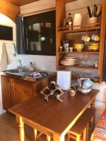 a kitchen with a wooden table and a sink at Lou Bohème in Le Briou