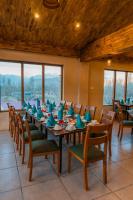 a large dining room with a long table and chairs at Dynasty Hotel Skardu in Skardu