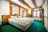 a bedroom with a large white bed in a room at Ringhotel Schlossberg in Neustadt