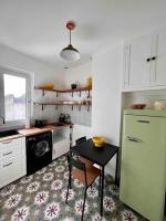 a kitchen with a table and a green refrigerator at Paris Home in Boulogne-Billancourt