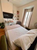 a bedroom with a bed and a flat screen tv at Paris Home in Boulogne-Billancourt