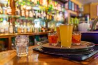 a tray with three drinks on a table in a bar at 1905 Basin Park Hotel in Eureka Springs