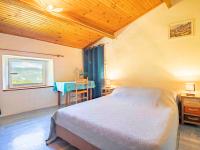 a bedroom with a bed and a table and a window at Holiday Home Le Cèdre - RSB100 by Interhome in Roche-Saint-Secret