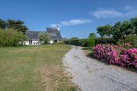 a house with pink flowers on the side of a gravel road at Parenthese relaxante les pieds dans l eau in Le Tour-du-Parc