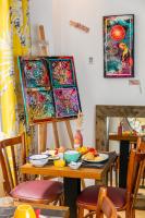 a table with plates of food and paintings on it at Hôtel Crayon in Paris