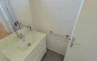 a white bathroom with a sink and a shower at Bright, contemporary apt in the Bel Air district in Paris