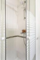 a shower with a glass door in a bathroom at Le cocon - DGI in Sartrouville