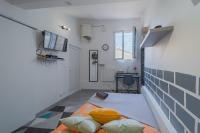 a room with a bed in the middle of a room at La Cloche Studio Hypercentre Mairie in Libourne