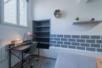 a room with a desk and a wall with blue tiles at La Cloche Studio Hypercentre Mairie in Libourne