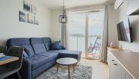 Televízia a/alebo spoločenská miestnosť v ubytovaní Apartamenty Sun & Snow Posesja Kapitańska