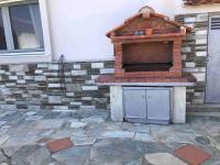 a brick oven sitting on top of a patio at Villa Casa Chrissy in Plagiárion