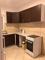 a kitchen with brown cabinets and a stove top oven at Villa Predlug in Čapljina