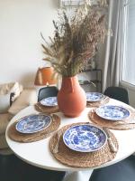 a table with blue and white plates and a vase at Massilia Calling love Appartement de standing 8 personnes Marseille proche métro parking facile in Marseille