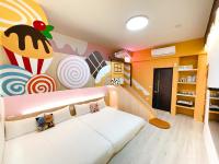 a childs room with a white couch and a mural at Misto B&amp;B in Taitung City