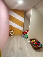 a childs room with a yellow and white striped wall at Misto B&amp;B in Taitung City