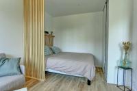 a bedroom with a bed and a large mirror at Le Normand- Bois d&#39;arcy in Bois-dʼArcy