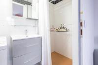 a white bathroom with a sink and a shower at Calenzana Trè - Appt avec piscine partagée in Calvi