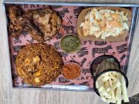 a plate of food with meat and rice and sauce at KoKo Palm Inn LTD in Accra