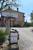 a sign in front of a building with a welcome sign at Apartman Fachin in Motovun