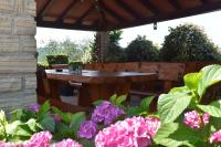 a patio with a table and some flowers at Apartman Fachin in Motovun