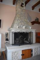 a fireplace in a room with a stone oven at Apartman Fachin in Motovun