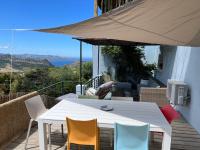 a white table and chairs on a balcony at Casa Costa in Barbaggio