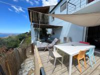 a patio with a white table and chairs on a balcony at Casa Costa in Barbaggio