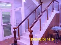 a staircase in a house with a glass railing at Xinchuan B&amp;B in Dayi
