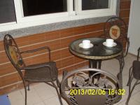 a table with two chairs and a table with two cups at Xinchuan B&amp;B in Dayi