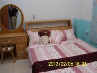 a bedroom with a bed with a teddy bear on it at Xinchuan B&amp;B in Dayi