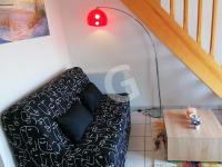 a living room with a black couch and a red lamp at Appartement La Tranche-sur-Mer, 3 pièces, 5 personnes - FR-1-357-309 in La Tranche-sur-Mer