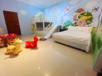 a bedroom with a bed and some toys in it at Hualien Lidu House in Hualien City