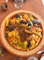 a plate of food with meat and vegetables on a table at Riad Belharra in Marrakech