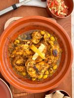 an orange bowl of food on a wooden table at Riad Belharra in Marrakech