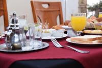 a table with a plate of food and orange juice at Golden Beach Appart'hotel in Agadir