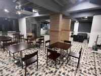 a restaurant with tables and chairs in a room at Palladium Luxury Suites Financial District Unit I in Hyderabad