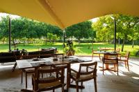a patio with tables and chairs and an umbrella at Hotel Rural Xereca in Puig D’en Valls