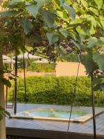 a hot tub in a garden under a tree at Hotel Rural Xereca in Puig D’en Valls