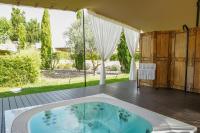 a hot tub on a deck with a view of a yard at Hotel Rural Xereca in Puig D’en Valls