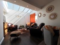 a living room with leather furniture and a skylight at 30 m des Plages - Port du Magouër - 6 invités in Plouhinec