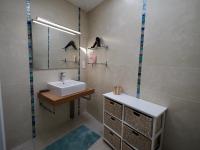 a bathroom with a sink and a mirror and a sink at 30 m des Plages - Port du Magouër - 6 invités in Plouhinec