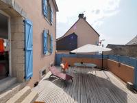 a balcony with a chair and an umbrella on a building at 30 m des Plages - Port du Magouër - 6 invités in Plouhinec
