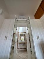 A bed or beds in a room at Sardegna Costa Corallina Appartamento Luxury Vista Mare in splendido villaggio - IUN R6511