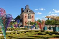 a garden with colorful butterflies in front of a building at Thunder Roadhouse in La Mothe-Saint-Héray