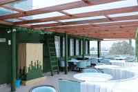 a group of tables and chairs in a patio at Hotel 7 Heaven in Dehradun
