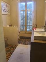 a bathroom with a sink and a window at Manoir en Crau in Arles