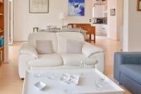 a living room with a white couch and a table at Escapade au calme tout pres de la plage in Penmarch