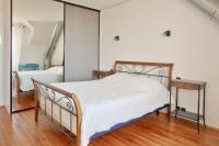 a bedroom with a bed and a mirror at Escapade au calme tout pres de la plage in Penmarch